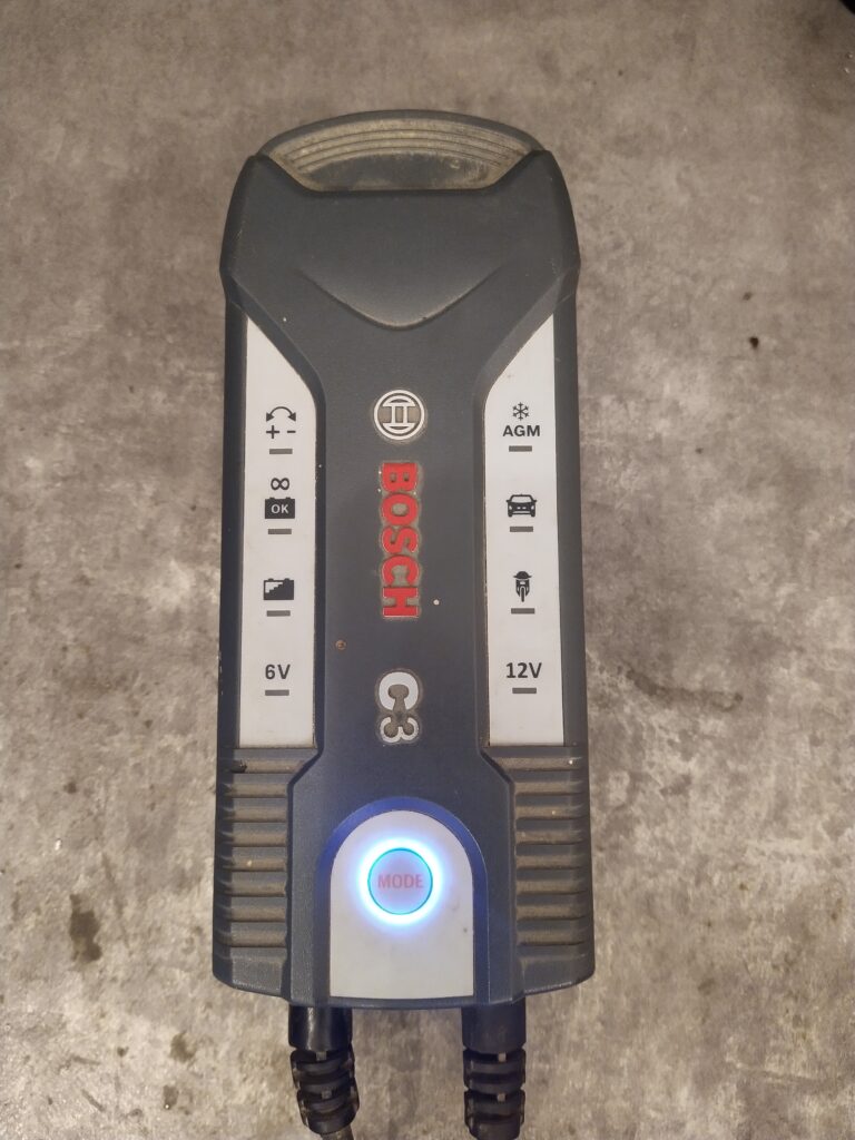 Nabíječka Bosch C3 po připojení do sítě. Tlačítko MODE je modře podsvíceno a nabíječka je nečinná. Takto se nabíječka chovala před opravou.